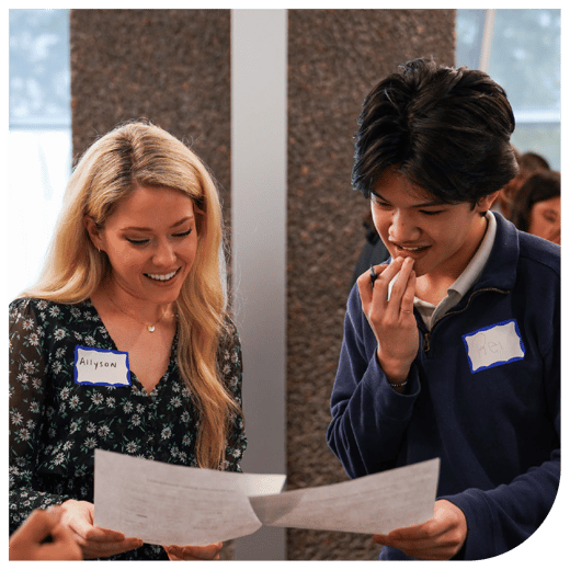 Two people holding papers